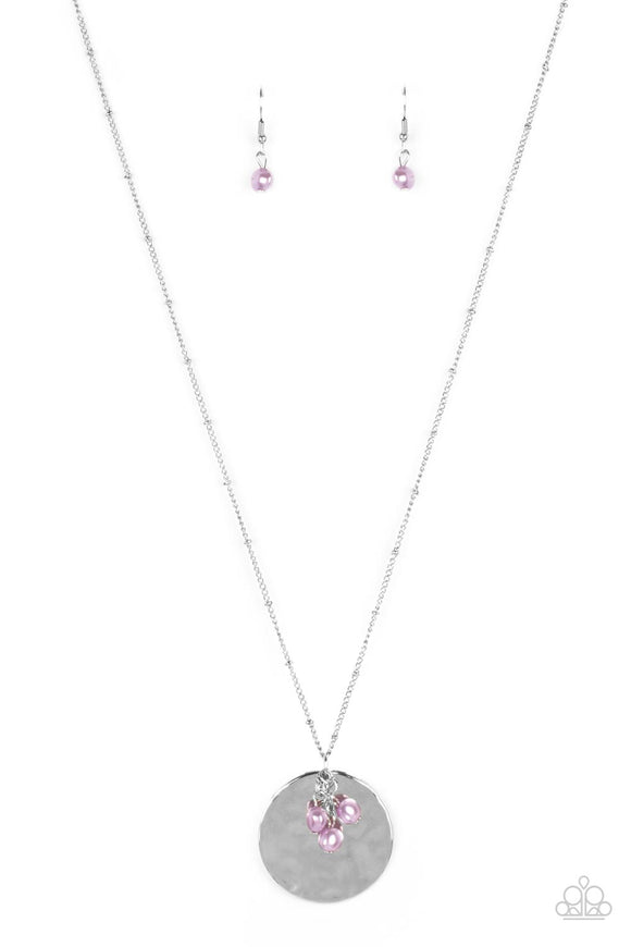 A shimmering wavy silver disc sways from the bottom of a lengthened silver satellite chain. A cluster of light purple pearl beads dangles charmingly in front of the disc creating a tranquilly mystical pendant. Features an adjustable clasp closure.  Sold as one individual necklace. Includes one pair of matching earrings.