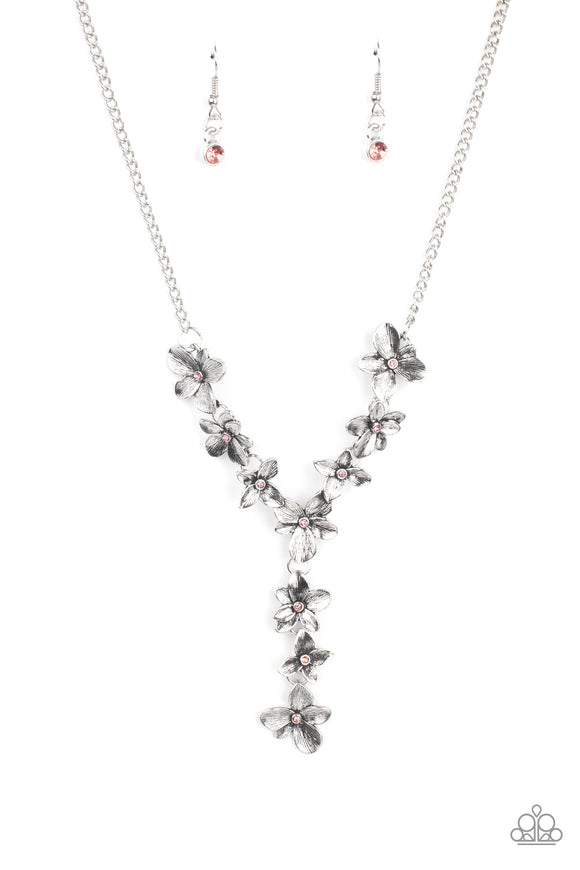 Dotted with dainty pink rhinestone centers, whimsical silver flowers delicately link into an extended pendant below the collar for an ethereal fashion. Features an adjustable clasp closure.  Sold as one individual necklace. Includes one pair of matching earrings.
