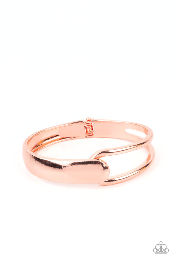 A flat shiny copper bar and airy shiny copper frame delicately overlap around the wrist, creating an oversized cuff-like bangle for a modern twist. Features a hinged closure.  Sold as one individual bracelet.