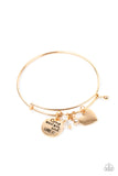 Infused with a shiny gold heart frame, a dainty gold disc stamped in the phrase, "Come what may and love it," joins pearl, crystal, and rhinestone charms along a bangle-like bracelet for a whimsy look. Features a toggle closure.  Sold as one individual bracelet.