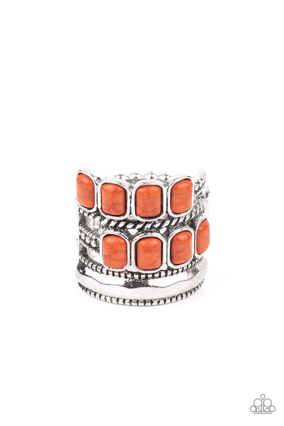 Mismatched rows of Adobe rectangular stone beads, twisted silver and studded silver bars, and a faceted silver band haphazardly layer across the finger, coalescing into a colorfully rustic centerpiece. Features a stretchy band for a flexible fit.  Sold as one individual ring.