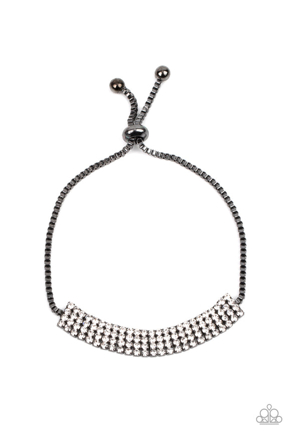 Stacked rows of sparkling white rhinestones delicately connect with shiny gunmetal box chain around the wrist, creating a stunning centerpiece. Features an adjustable sliding bead closure.  Sold as one individual bracelet.