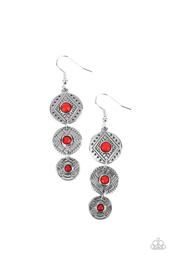 A trio of silver discs engraved with tribal patterns and dotted with red bead centers creates a rustic token as they dangle dramatically. Earring attaches to a standard fishhook fitting.  Sold as one pair of earrings.