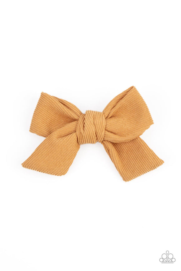 A golden yellow corduroy ribbon delicately knots into a dainty bow, creating a rustic centerpiece. Features a standard hair clip on the back.  Sold as one individual hair clip.