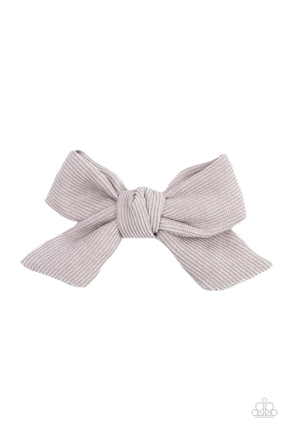 An Ultimate Gray corduroy ribbon delicately knots into a dainty bow, creating a rustic centerpiece. Features a standard hair clip on the back.  Sold as one individual hair clip.