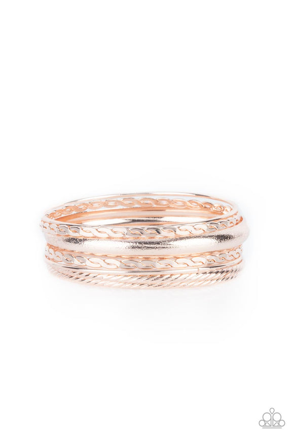 Featuring a polished finish, a mismatched collection of textured, braided, hammered, and plain rose gold bangles stack across the wrist for a classic metallic look.  Sold as one set of seven bracelets.