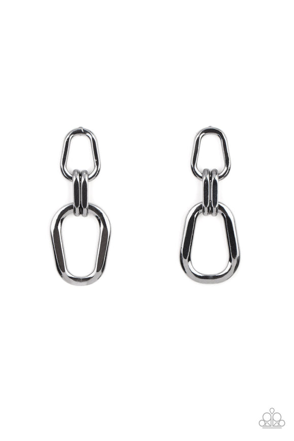 A collection of asymmetrical gunmetal oval frames boldly link into an edgy lure, resulting in an intense industrial statement piece. Earring attaches to a standard post fitting.  Sold as one pair of post earrings.