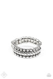 A twisted silver band is flanked by rows of antiqued silver studs, creating a rustically layered look across the finger. Features a dainty stretchy band for a flexible fit.