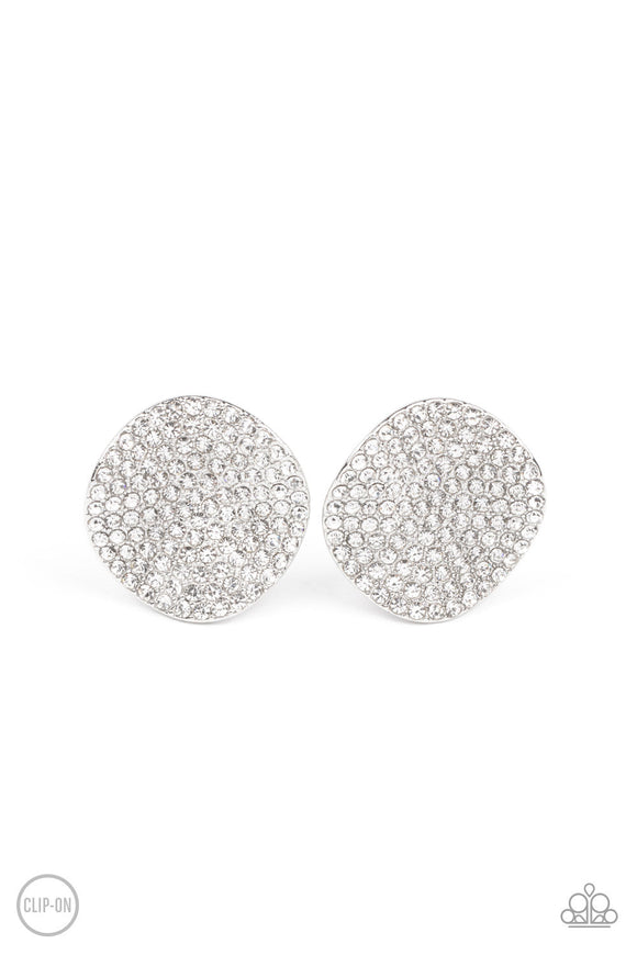 The front of a warped silver disc is encrusted in row after row of blinding white rhinestones, resulting in a refined display. Earring attaches to a standard clip-on fitting.  Sold as one pair of clip-on earrings.
