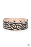 A black leather band is etched in a runic-like pattern, creating a rustic centerpiece around the wrist. Features an adjustable snap closure.  Sold as one individual bracelet.