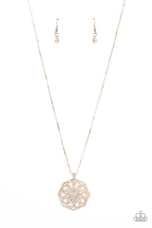 A spiraling floral frame is encrusted in glassy white rhinestones, resulting in a timeless pendant at the bottom of a dainty rose gold box chain. Features an adjustable clasp closure.  Sold as one individual necklace. Includes one pair of matching earrings.