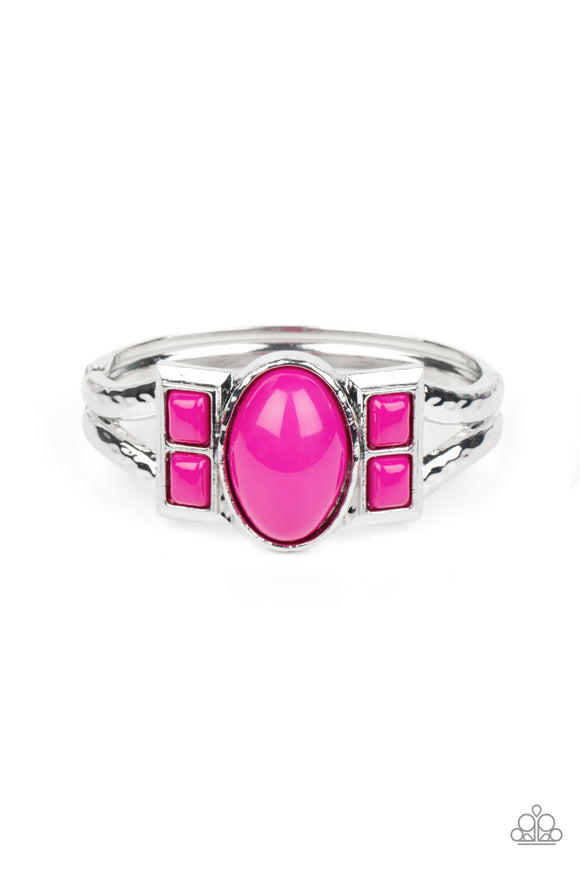 An oversized oval Fuchsia Fedora bead is flanked by pairs of stacked Fuchsia Fedora square beads across the center of a hammered silver bangle-like bracelet, creating a bold pop of color atop the wrist. Features a hinged closure.  Sold as one individual bracelet.