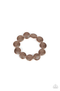 Hammered in antiqued details, a rustic collection of copper beads are threaded along a stretchy band around the wrist for a wildly adventurous look.  Sold as one individual bracelet.