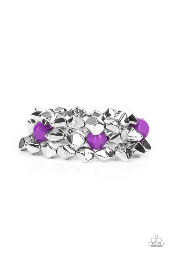 Infused with pops of purple accents, a faceted series of silver beads are threaded along stretchy bands around the wrist for a flashy fashion.  Sold as one set of three bracelets.