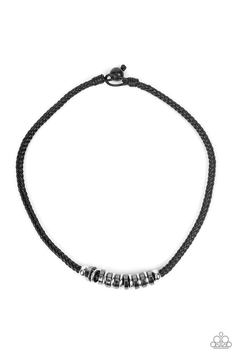 A section of gritty gunmetal and silver discs glide along the center of a braided black cord, creating an urban centerpiece below the collar. Features a button loop closure.  Sold as one individual necklace.