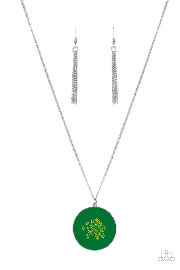 Encased in a glassy fitting, a dainty bouquet of firework flowers blooms across a Leprechaun backdrop, resulting in a colorful floral pendant at the bottom of an extended silver chain. Features an adjustable clasp closure.  Sold as one individual necklace. Includes one pair of matching earrings.