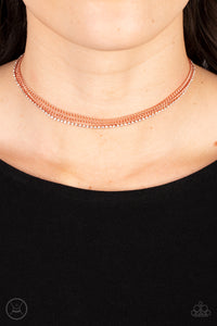 Two shiny copper chains and a single strand of dainty white rhinestones effortlessly layer around the neck, resulting in a radiant look. Features an adjustable clasp closure.  Sold as one individual choker necklace. Includes one pair of matching earrings.