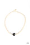 A faceted ceramic black bead is knotted in place along a braided twine-like cord below the collar, creating an authentically earthy centerpiece. Features a button loop closure.  Sold as one individual necklace.