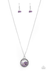 Infused with a sleek silver fitting, an earthy collection of dainty amethyst stones are encased in a glassy frame at the bottom of a dainty silver chain. Features an adjustable clasp closure.  Sold as one individual necklace. Includes one pair of matching earrings.