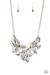 A textured collection of silver holly-like leaves are dotted with dainty green rhinestones as they bloom below the collar, invoking a festive spirit. Features an adjustable clasp closure.  Sold as one individual necklace. Includes one pair of matching earrings.