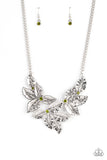 A textured collection of silver holly-like leaves are dotted with dainty green rhinestones as they bloom below the collar, invoking a festive spirit. Features an adjustable clasp closure.  Sold as one individual necklace. Includes one pair of matching earrings.