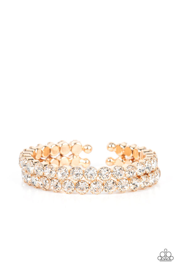 Encased in sleek gold fittings, two oversized rows of glassy white rhinestones stack into a blinding cuff around the wrist for a jaw-dropping look.  Sold as one individual bracelet.