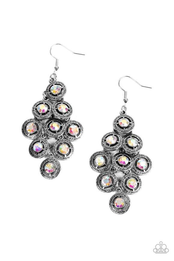 Dotted with iridescent rhinestone centers, tiers of textured silver frames cascade from a metallic backdrop for a stellar tasseled look. Earring attaches to a standard fishhook fitting.   Featured inside The Preview at GLOW! Sold as one pair of earrings.  New Kit