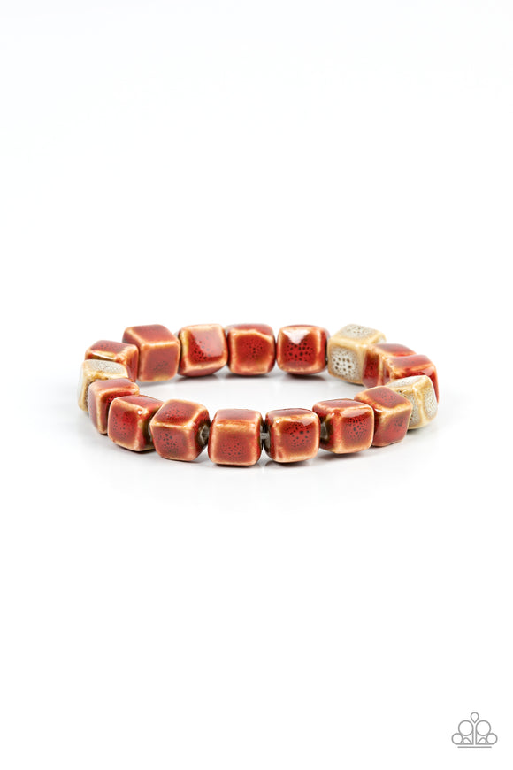 Featuring distressed red and brown glazed finishes, a rustic collection of ceramic cube beads are threaded along stretchy bands around the wrist for a colorful flair.  Sold as one individual bracelet.