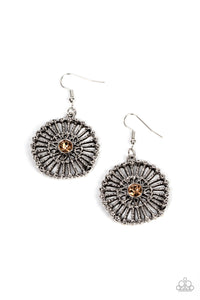 Hammered silver spokes flare out from a golden topaz rhinestone center, resulting in a studded silver frame. Earring attaches to a standard fishhook fitting.  Sold as one pair of earrings.