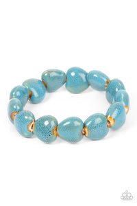 Glazed in a distressed blue finish, ceramic-like heart shaped beads are threaded along stretchy bands around the wrist for an earthy flair.  Sold as one individual bracelet.