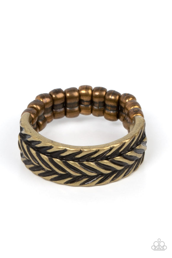Etched in rustic patterns, slanted rows of chevron-like textures alternate across a dainty brass band. The centermost row is raised, adding 3-dimensional detail to the rustic centerpiece. Features a dainty stretchy band for a flexible fit.  Sold as one individual ring.