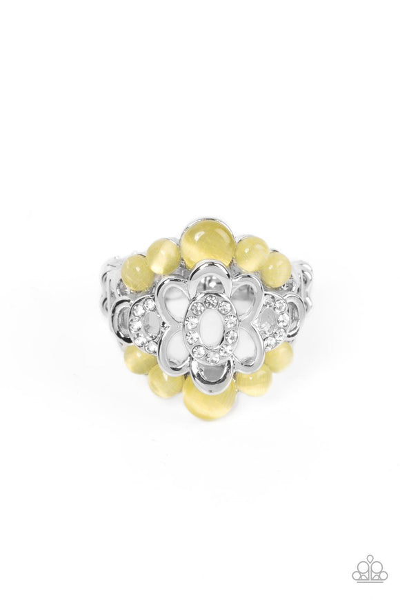 A white rhinestone dotted silver flower blooms atop bubbly yellow cat's eye stone borders, coalescing into an effervescent sparkle atop the finger. Features a stretchy band for a flexible fit.  Sold as one individual ring.