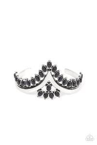 Black oval stones, encased in studded silver frames, line the edge of a daring V-shaped silver cuff. A gathering of black stones adorns the center of the bracelet, adding a finishing touch to the rustically regal cuff.  Sold as one individual bracelet.