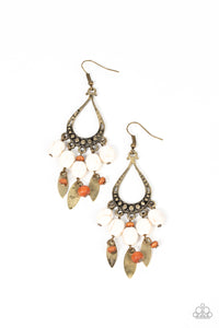 An earthy assortment of white stones, wooden beads, and rustic brass frames cascade from the bottom of a studded brass teardrop, resulting in an artisan inspired fringe. Earring attaches to a standard fishhook fitting.  Sold as one pair of earrings.