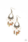 An earthy assortment of white stones, wooden beads, and rustic brass frames cascade from the bottom of a studded brass teardrop, resulting in an artisan inspired fringe. Earring attaches to a standard fishhook fitting.  Sold as one pair of earrings.