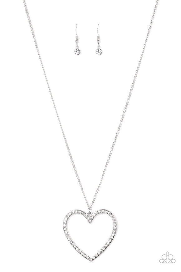 Dotted in dainty white rhinestones, an oversized silver heart frame swings from the bottom of an extended silver chain for a flirtatious sparkle. Features an adjustable clasp closure.  Sold as one individual necklace. Includes one pair of matching earrings.