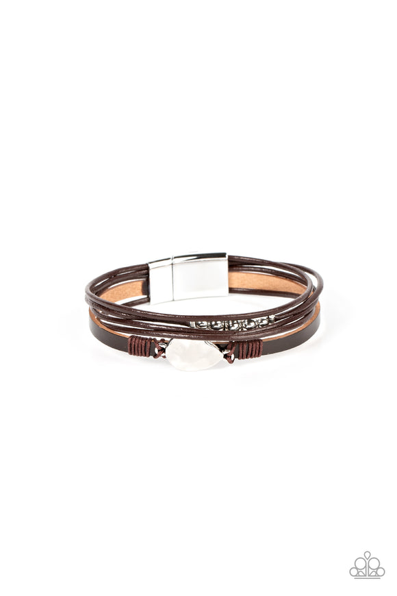 Infused with a silver beaded accent, rows of shiny brown cording join a brown leather band around the wrist. A hammered silver teardrop is knotted in place with brown thread, adding an artisanal touch to the rustic centerpiece. Features a magnetic closure.  Sold as one individual bracelet.
