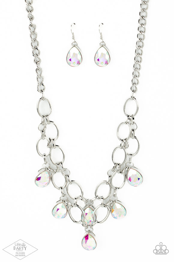 Joined by dainty silver links, two rows of dramatic silver chain layer below the collar in a fierce fashion. Iridescent teardrop gems drip from the glistening layers, adding a timeless shimmer to the show-stopping piece. Features an adjustable clasp closure.  Sold as one individual necklace. Includes one pair of matching earrings.