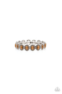 Bordered in dainty silver studs, pairs of brown cat's eye stones are threaded along stretchy bands around the wrist for a dreamy fashion.  Sold as one individual bracelet.