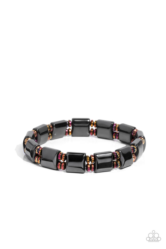 Pairs of metal discs coated in an oil fill finish, stack between metallic, square-like beads in a sleek gunmetal finish. The elements are threaded along stretchy bands, wrapping comfortably around the wrist.  Sold as one individual bracelet.