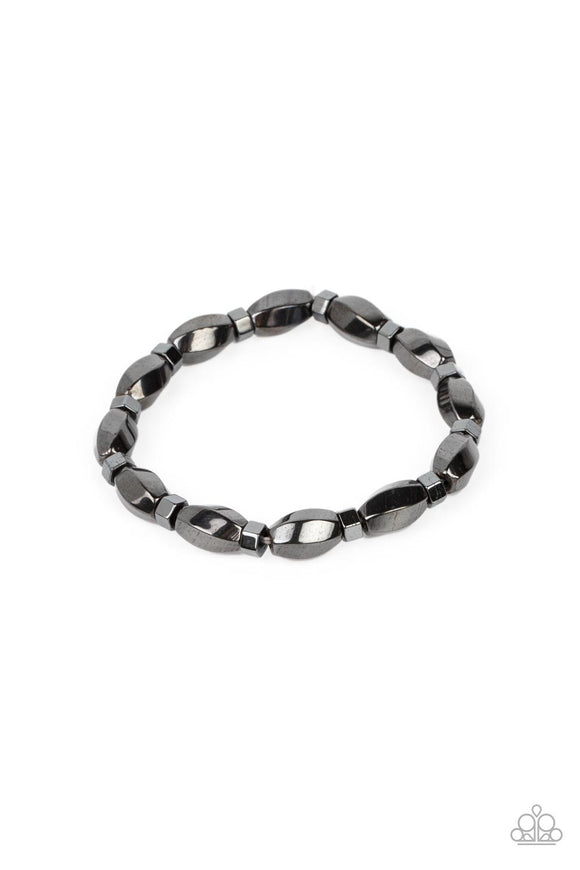 Faceted gunmetal beads and hexagonal rings alternate along stretchy bands around the wrist, resulting in a gritty centerpiece.  Sold as one individual bracelet.