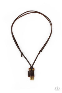 A piece of brown leather wraps around a pair of brass bullets, creating an edgy urban pendant at the bottom of knotted strands of brown leather. Features an adjustable sliding knot closure.  Sold as one individual necklace.