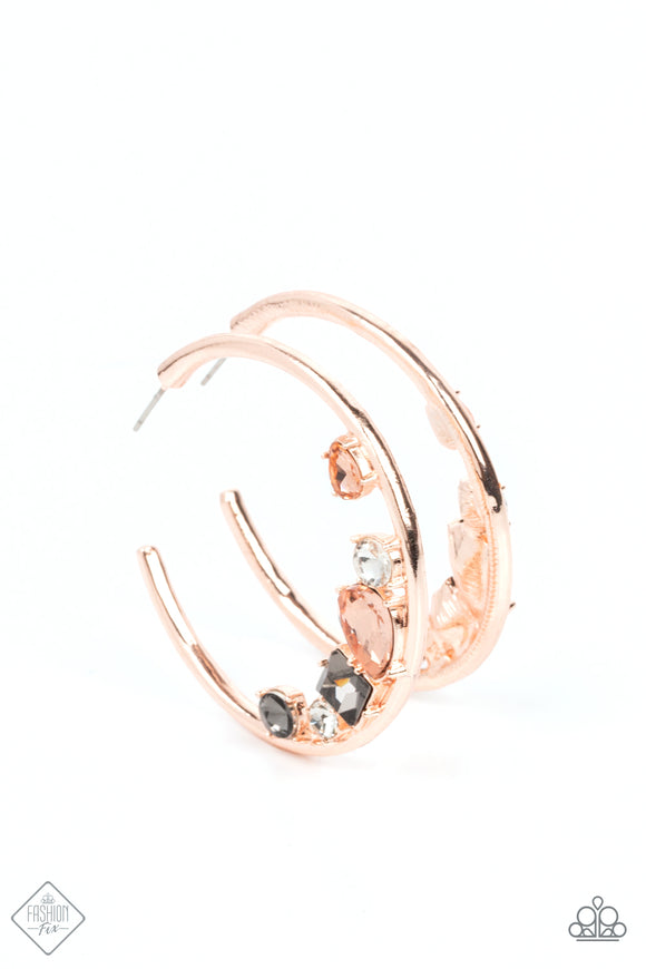 Featuring vivacious peach, white, and smoky rhinestones, a mashup of mismatched gems gather along the bottom edge of a smooth rose gold hoop, creating an extravagant lure. Earring attaches to a standard post fitting. Hoop measures approximately 1 3/4