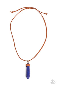 Wrapped in suede, an oversized lapis lazuli stone pendulum glides along a strand of brown suede across the chest for an earthy flair. Features an adjustable sliding knot closure.