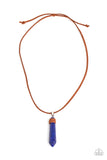 Wrapped in suede, an oversized lapis lazuli stone pendulum glides along a strand of brown suede across the chest for an earthy flair. Features an adjustable sliding knot closure.