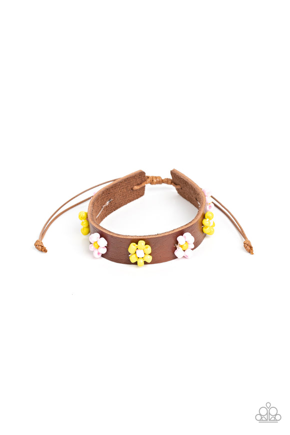 Pink and yellow beads bloom into vivacious flowers across the front of a brown leather band, bursting into a colorful floral accent. Features an adjustable sliding knot closure.  Sold as one individual bracelet.
