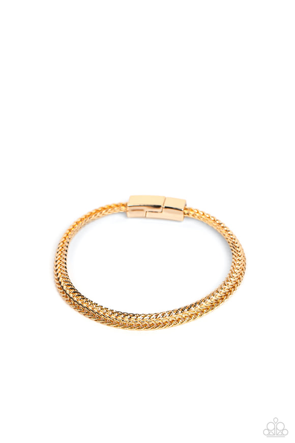 Intricate gold chains interlock into an edgy centerpiece around the wrist, resulting in a gritty statement piece. Features a magnetic closure.  Sold as one individual bracelet.