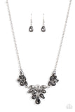 Varying in cut and shimmer, bubbly clusters of mismatched white and smoky rhinestones coalesce into three sparkly frames for a captivating statement below the collar. Features an adjustable clasp closure.  Sold as one individual necklace. Includes one pair of matching earrings.