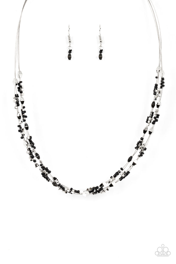 A dainty collection of faceted silver beads, black seed beads, and silver cubes are threaded along multiple strands of silver wire below the collar, creating clustered layers. Features an adjustable clasp closure.  Sold as one individual necklace. Includes one pair of matching earrings.