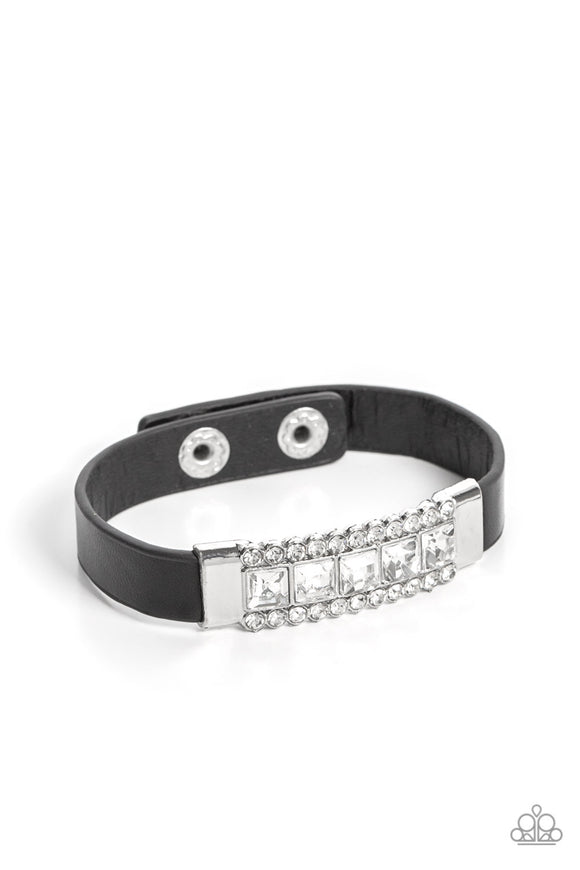 Flanked between two rows of glassy white rhinestones, a section of square cut white rhinestones adorns the center of a silver frame that attaches to a dainty black leather band around the wrist for a sassy sparkle. Features an adjustable snap closure.  Sold as one individual bracelet.